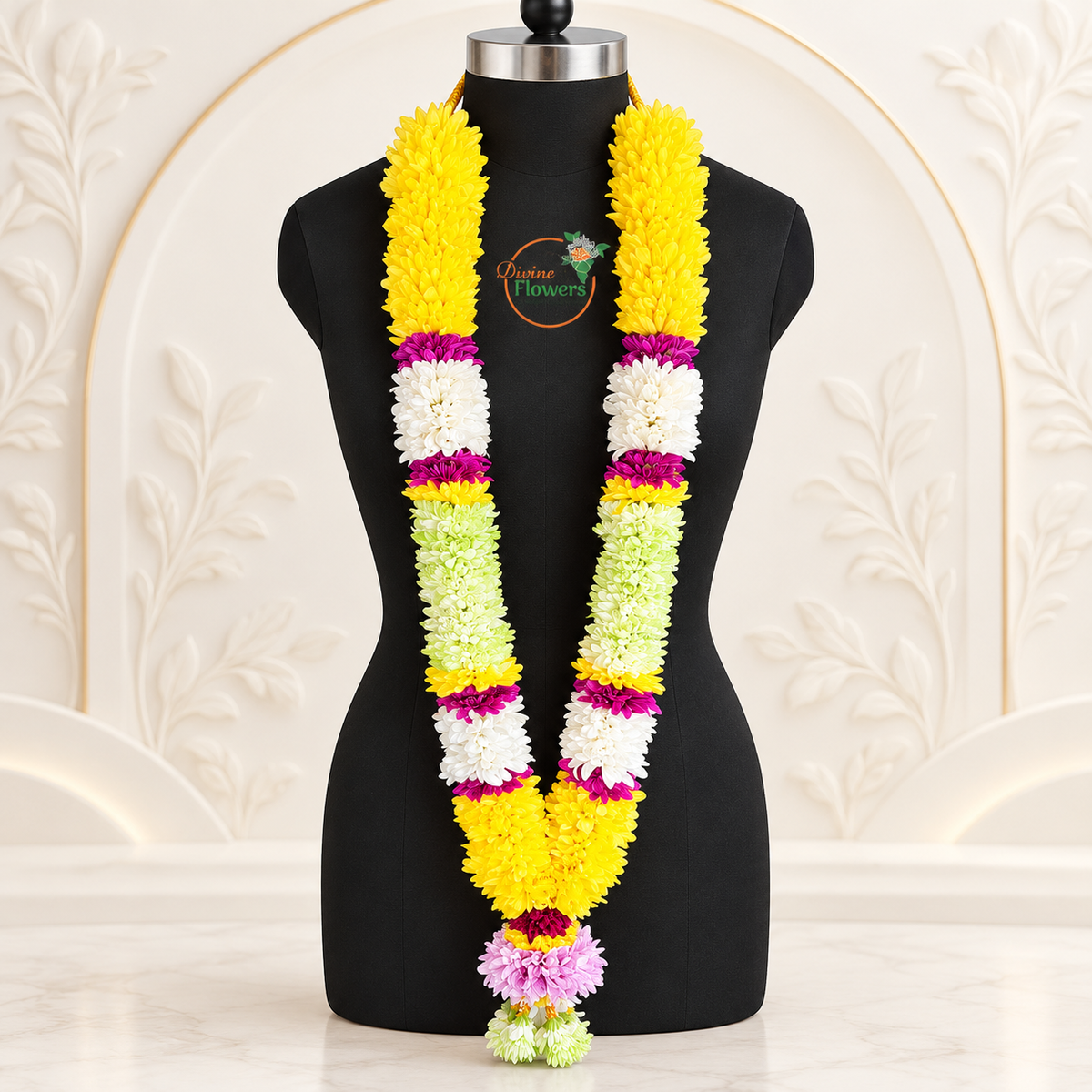 Mums Chamanti wedding garland WG-MGR-001 with green tassels on a black mannequin with Divine Flowers branding